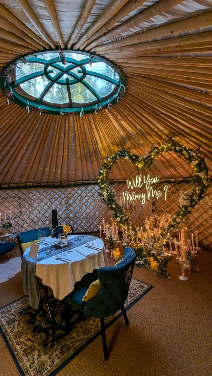 A romantic, private dinner for 2 is set up in the private yurt restaurant for 2. The large heart shaped arch adorned with fairy light, roses, and over 56 candles sets the scene. Hanging from the heart is a large Will You Marry? Led sign, a bold statement for such a special occasion. After popping the question enjoy a 3 course dinner cooked by your own private chef.