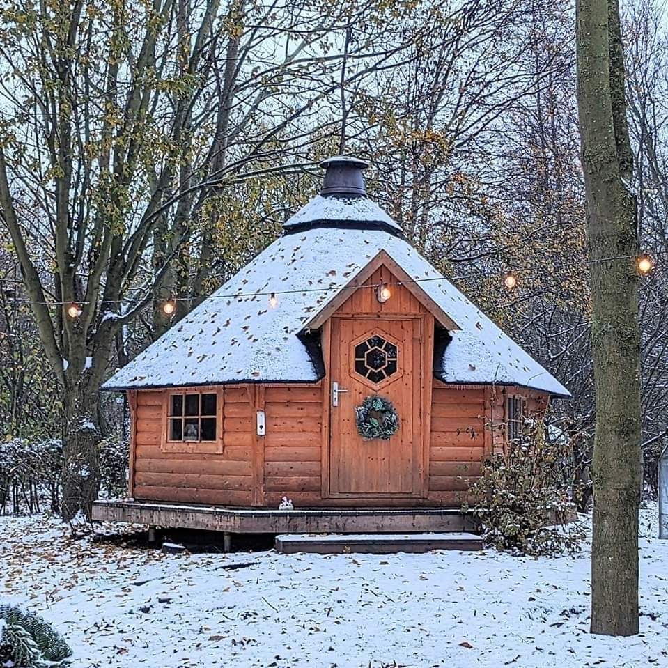 The indoor BBQ cabin, sits in the woodland covered in snow. Enjoy a BBQ cabin no matter the weather when booking a romantic, Christmas, hot tub break Yorkshire.