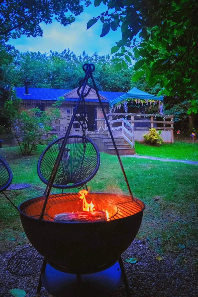 Romantic getaways near me on the Yorkshire and Nottingham border, a secluded woodland lodge with fairy lights, a private covered hot tub on the private deck and a flaming garden fire pit.