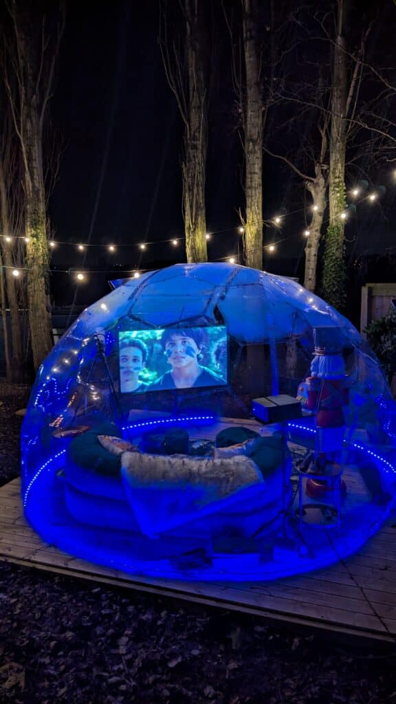 The cinema dome at night with a film viewing a luxury experience with a luxury canal boat stay at Hawthorn Hideaway.