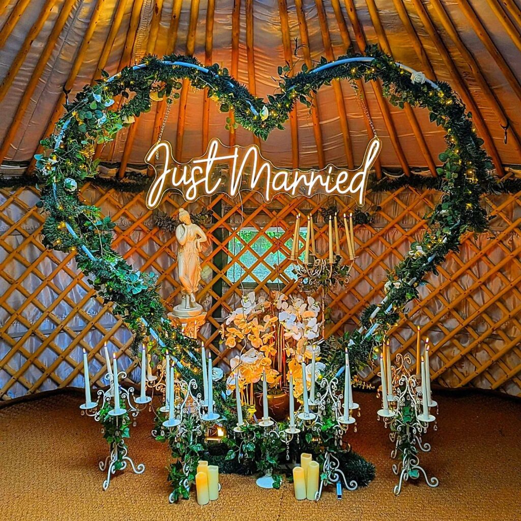 Honeymoon in Yorkshire setup with heart arch, candles and "Just Married" sign at Hawthorn Hideaway