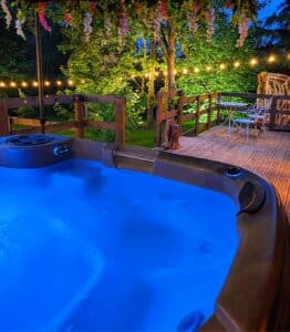 Romantic hot tub under festoon lighting at Hawthorn Hideaway, magical night and romantic getaways in Yorkshire, a romantic retreat for honeymoon hot tub breaks.